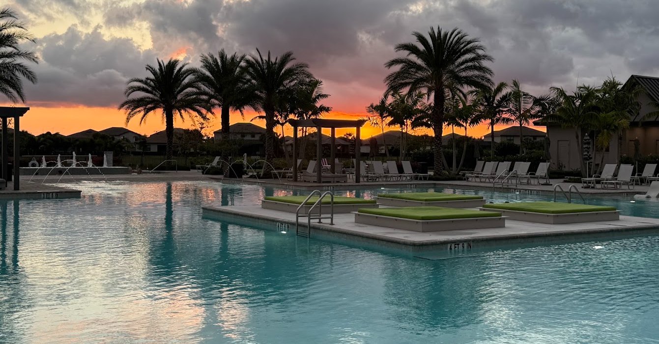 The Verdana Village resort pool at sunset